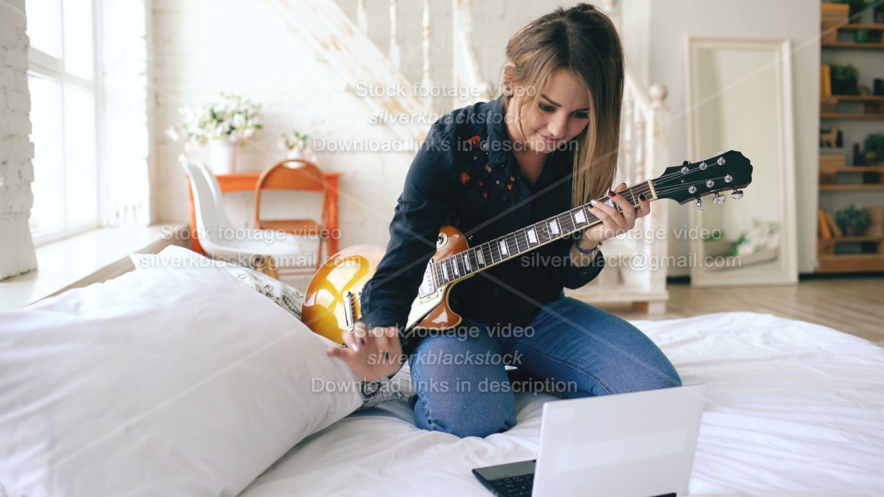 Kara practicing guitar.jpg